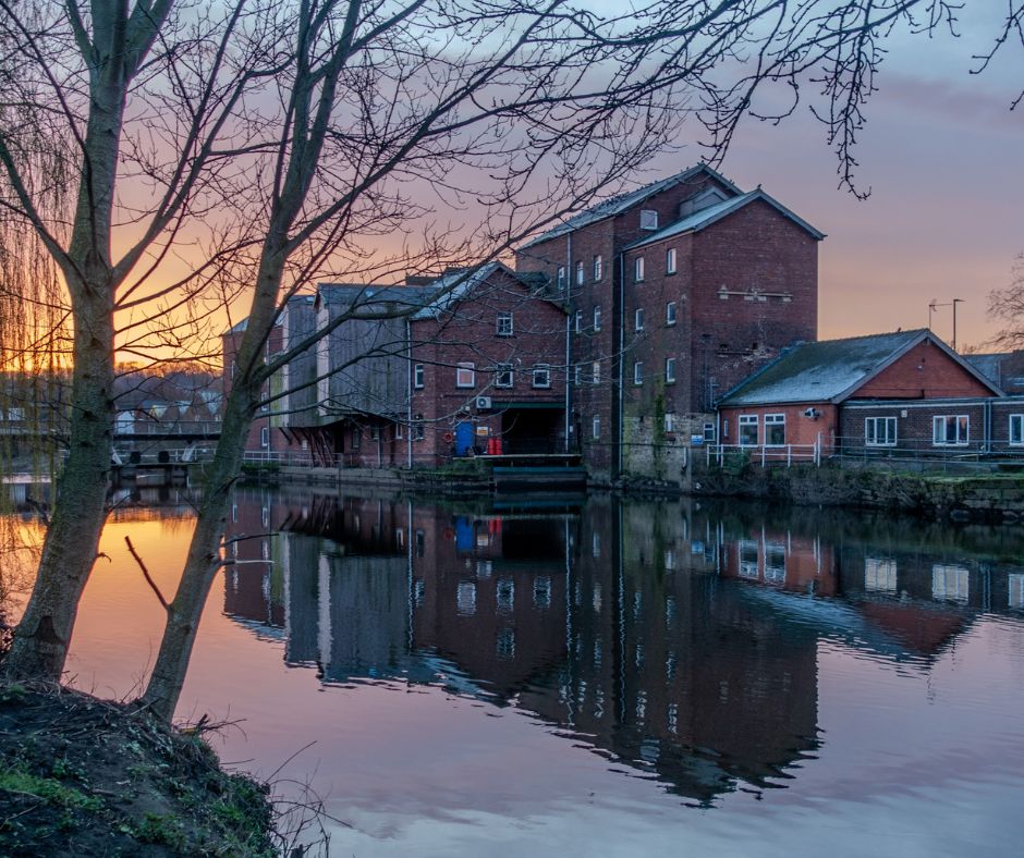 A sunset over the River Aire and Queen's Mill